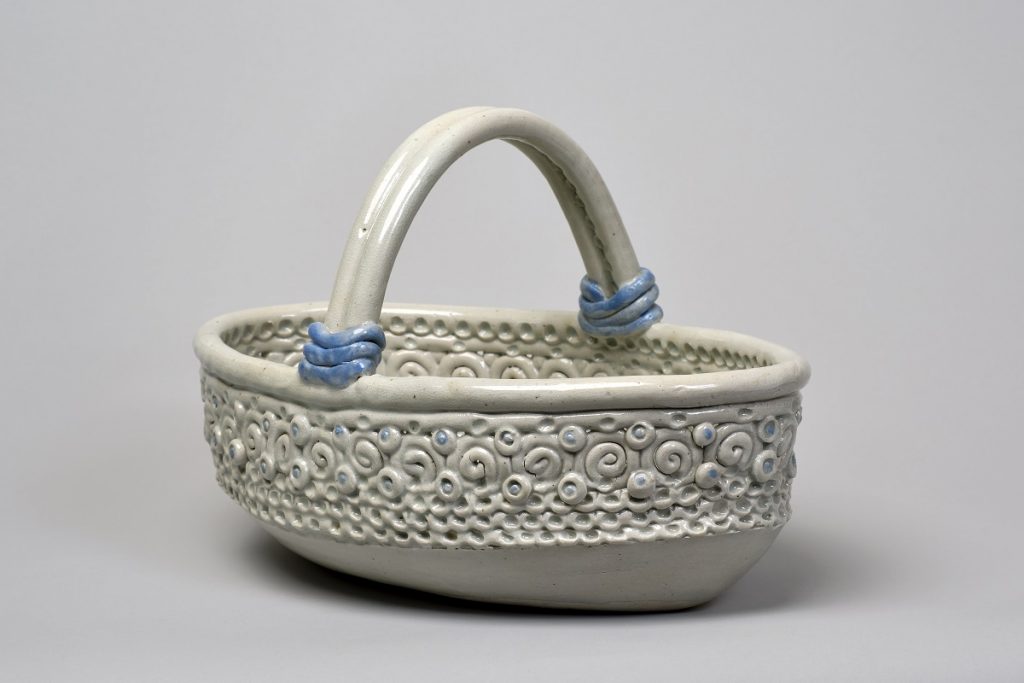 Image of a white ceramic basket-like bowl with blue accents.